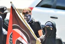 Antifa Mob STORMS Church, Attack Conservative Star Masked protesters holding a black and red flag