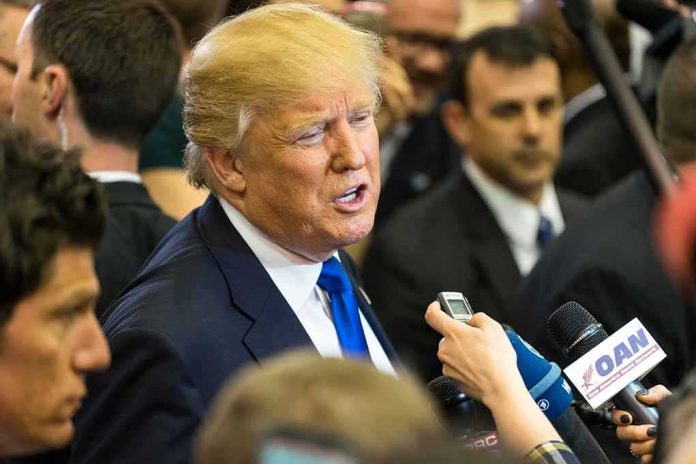 man in suit speaking to reporters with microphones