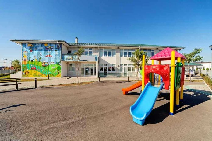Colorful playground slide in front of a building.
