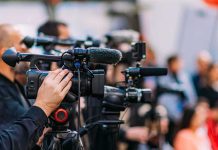 Maniac Charges at Cops With Sword Video cameras on tripods at a media event