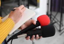 South Park’s Wild Rebrand Sparks Outrage Journalist holding two microphones while writing in a notebook