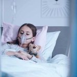 Child Euthanasia Goes Ahead – Toddler DEAD Child in hospital bed with oxygen mask holding teddy bear