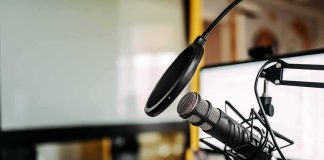 Podcast microphone with pop filter on desk