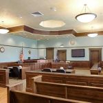 Another Boston Mom Murders Her Children Empty courtroom with wooden benches and judge's bench