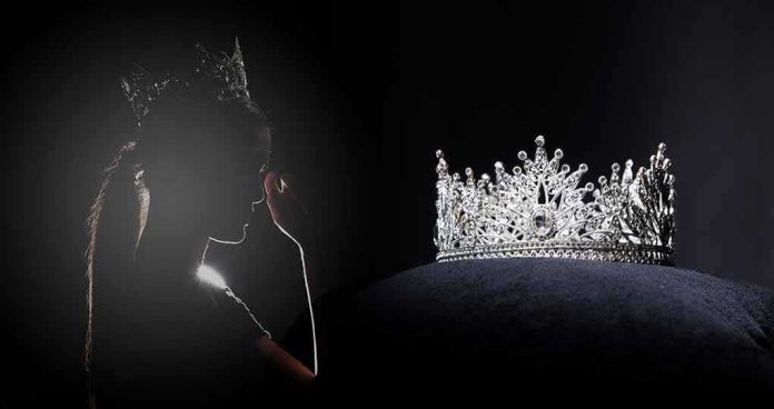 shutterstock_1443823805 Silhouette of a crowned woman beside a jeweled tiara on a cushion