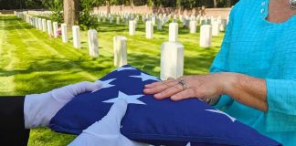 Folded American flag presented at a cemetery