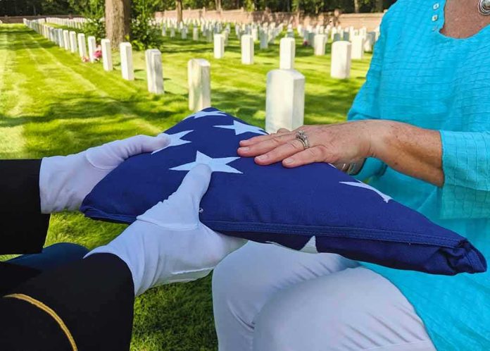 Folded American flag presented at a cemetery