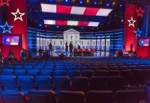 Pricey Trumpapalooza a Dud – GOP Scrambles To Fill Seats Debate stage with red and blue lighting and empty audience seats