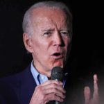 Joe Biden speaking into a microphone