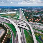 Illegal Migrant WHACKED By Semi Truck On The Run Aerial view of a multi-level highway interchange