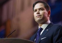 Nazi Meme Blasts Rubio’s TOP Aide man in suit speaking at podium