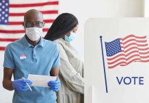 Trump’s Business Bro Wins Heated Congressional Primary Voters wearing masks at a polling station