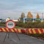 Polish Residents BRACE For Russian Invasion Ukraine border crossing with stop sign and barrier