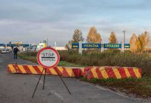 Polish Residents BRACE For Russian Invasion Ukraine border crossing with stop sign and barrier