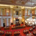 Shocking ‘Shoot Yourself’ Claim Rocks Congress Legislative chamber with red carpet and chandeliers