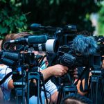 Air Force Picks Contractor To Build First CCA Drones! TV news cameras crowding together at an outdoor event