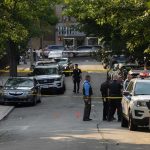 Gunfire Erupts Outside Notre Dame University Police officers secure a residential street with patrol cars and yellow tape