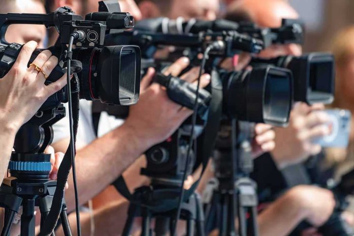 shutterstock_2692761619-5 television cameras on tripods at a media event