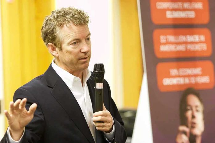 Rand Paul speaking with a microphone during an indoor event