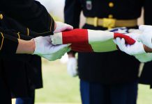 What Happened to Widow of Airman Killed in Iran Is Disgusting Military personnel folding a flag during a ceremonial event