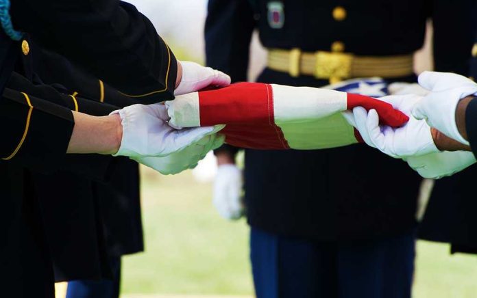Military personnel folding a flag during a ceremonial event