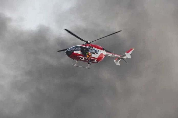 Rescue helicopter hovers amid thick smoke