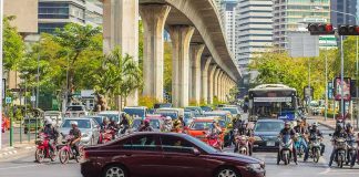 Urban traffic at intersection with motorbikes and car