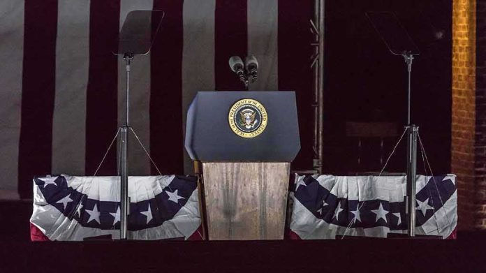 shutterstock_636136928-1 Presidential podium with microphones and teleprompters