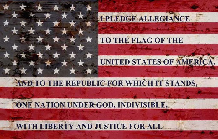 American flag with pledge text on a weathered surface