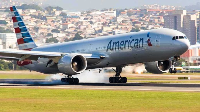 airliner landing on runway with smoke from tires