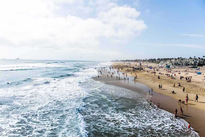 shutterstock_697274677 Crowded sandy beach with people by the shoreline