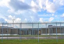Small Cages Found Outside ICE Detention Facility Prison yard behind chain-link and razor wire fence