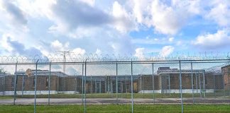 Small Cages Found Outside ICE Detention Facility Prison yard behind chain-link and razor wire fence