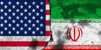 Flags of the United States and Iran split by a cracked seam