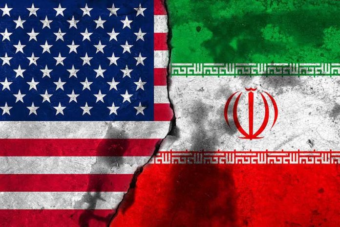 shutterstock_738497746 Flags of the United States and Iran split by a cracked seam