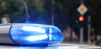 Man Arrested After Tying Wife to Chair to Watch Football Police car blue siren light flashing