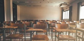 Campus Blocks Congressman From Speaking Empty classroom with rows of wooden desks and chairs