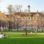 Trump Breaks Silence on Horrifying Cornell Rape Case Students relaxing on a campus quad in front of a brick academic building