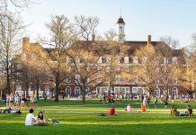 Trump Breaks Silence on Horrifying Cornell Rape Case Students relaxing on a campus quad in front of a brick academic building