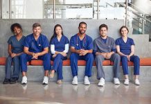 Group of medical professionals sitting on a bench
