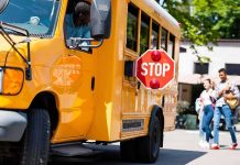 Deadly School Bus Horror Before Sunrise School bus with extended stop sign near students on sidewalk