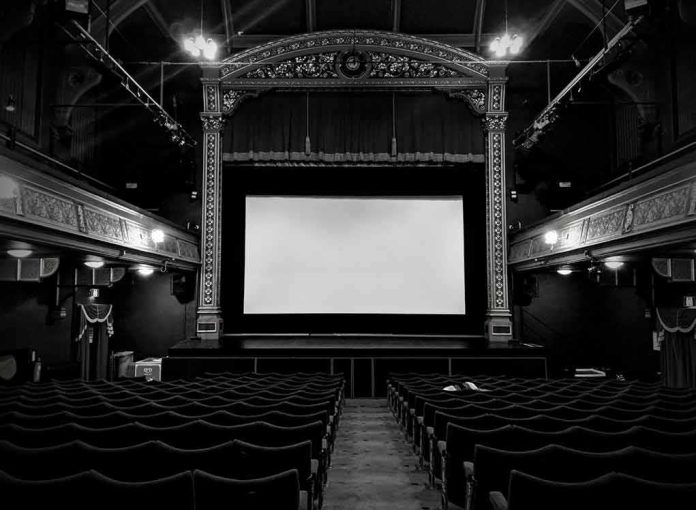 shutterstock_1308647422 Empty ornate theater with a blank screen