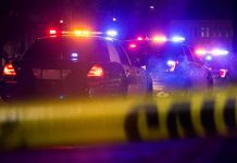 Suspect Arrested For Sexual Assault of Underage Boy is Trans Illegal Police cars with flashing lights behind yellow caution tape at night