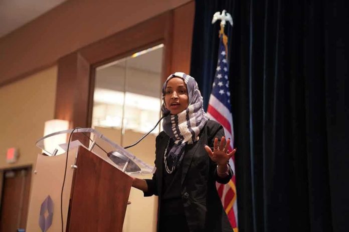 shutterstock_1397740550 Ilhan Omar speaking at a podium with a microphone