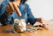 Trump Enrolls ALL Eligible Children Into His Account Person placing a coin into a savings jar labeled 'SAVINGS'