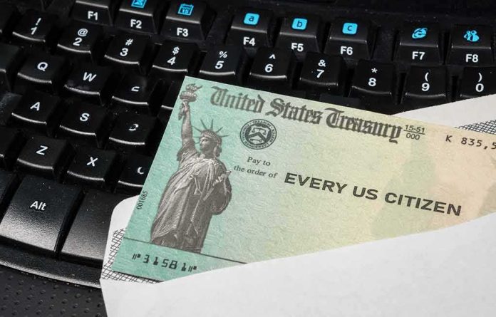 U.S. Treasury check partially out of an envelope on a computer keyboard