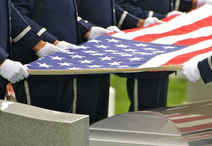 shutterstock_18489928 Honor guard holding an American flag over a casket