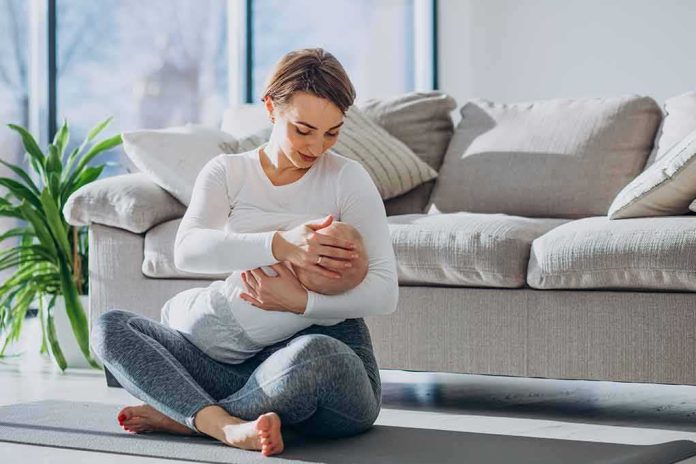 Mother breastfeeding baby on living room floor