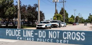 HORROR: 7-Year-Old Girl Fatally Stabbed in the Back by Stranger Police line barrier blocking a street with patrol vehicles behind