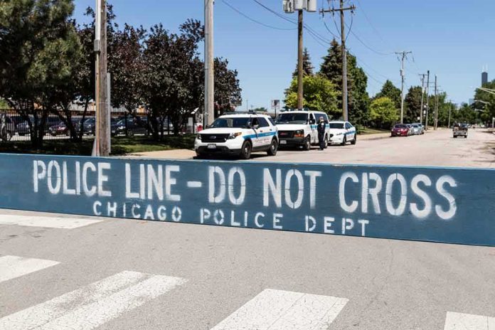 shutterstock_1983211409 Police line barrier blocking a street with patrol vehicles behind